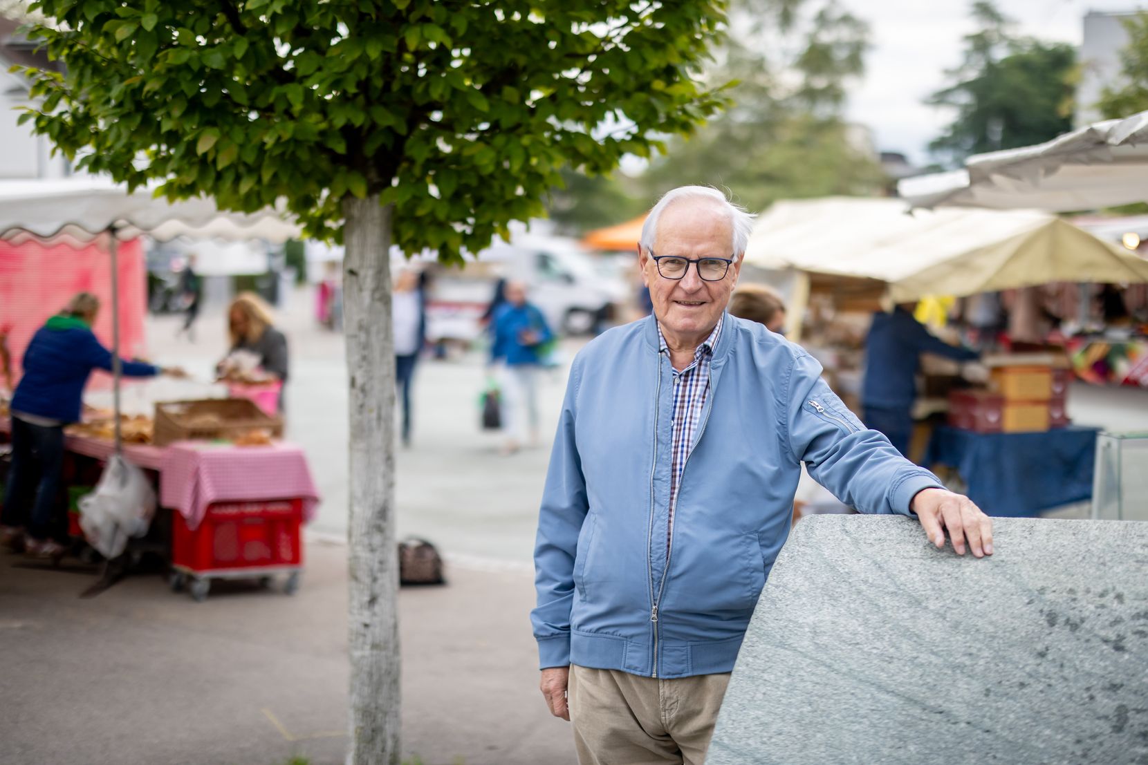 Ein Mann steht auf einem Marktplatz. 